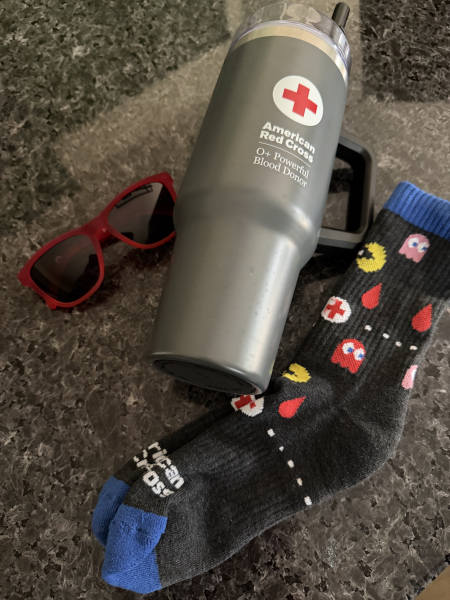 A pic of my sunglasses, giant water cup, and Pac-Man socks.